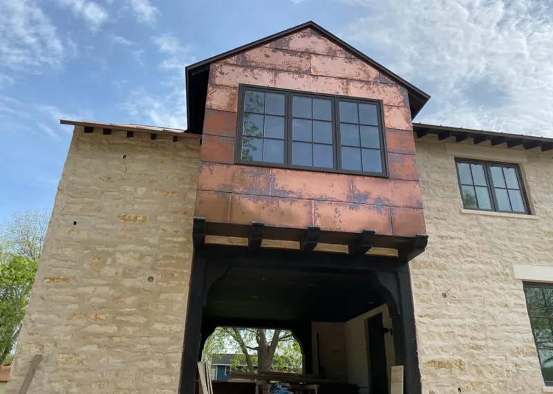 Copper metal panel facade on a stone building for Roof Repair in Erlanger